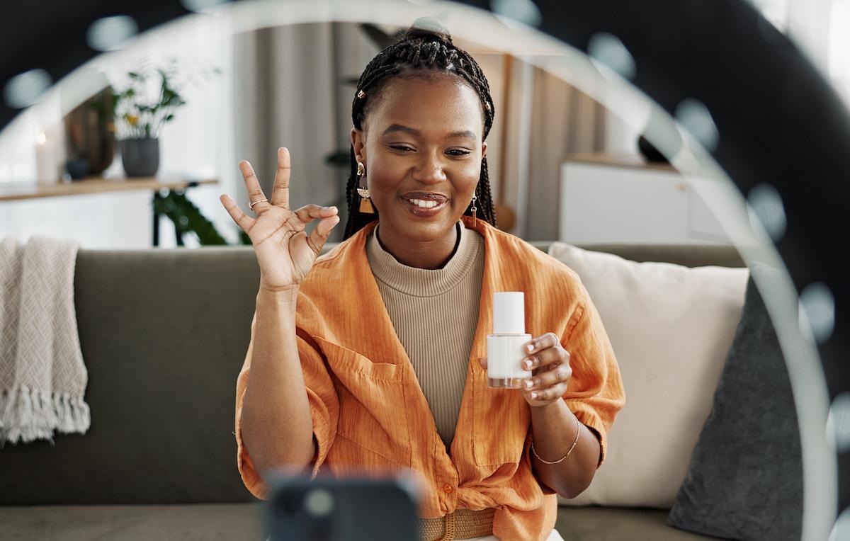 Video, content creator and black woman doing skincare for tutorial on social media or the internet.